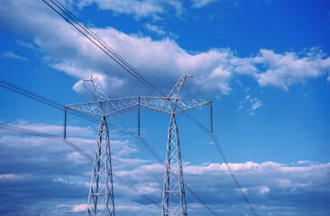  high-voltage  power lines at storm clouds.