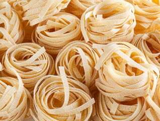 Uncooked tagliatelle pasta background