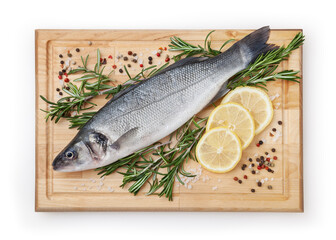 Fresh uncooked sea bass with lemon, rosemary and spice on wooden board isolated on white backdground with clipping path