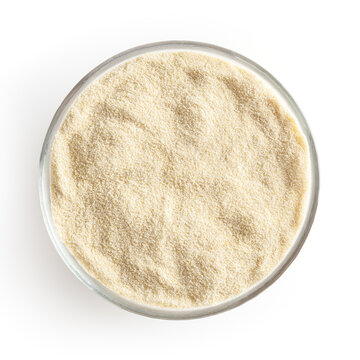 Semolina flour in glass bowl isolated on white background with clipping path