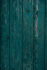 texture of a wooden fence.  fence painted green.  peeling paint on an old fence.  old wood texture.  photo can be used as a photophone, as a texture