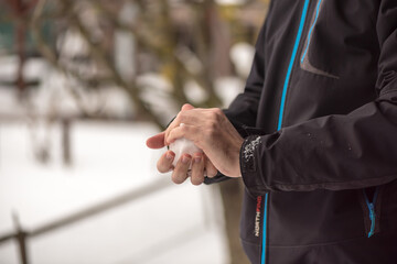 Winter time. Hands holding a snow ball.