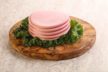 Slices pork sausage over board