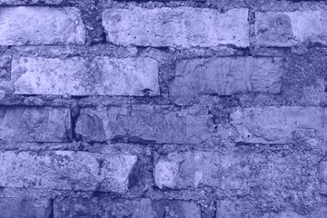 Background texture. Old brick wall surface of trendy color of the year 2022, copy space. Fashion purple shade