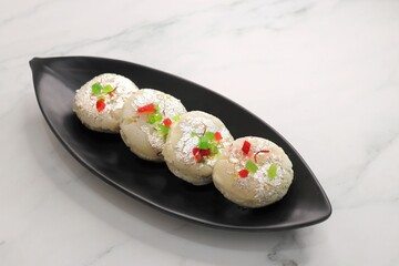 Rasmalai or Malai Sandwich, Roshmolai, Rasamalei is very popular Indian dessert. A sweet malai stuffing inside Rasgulla. It's a sweet delicacy made with Indian cottage cheese or chenna. Copy space.