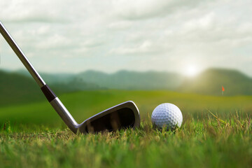 Golf balls and golf clubs as well as equipment used to play golf on green grass in a beautiful golf...