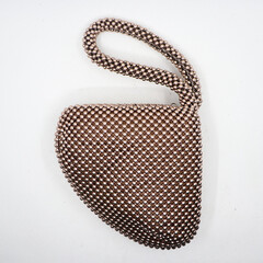 an elegant, small, fancy women's luxury fashion handbag made of stainless steel decorations isolated in a white background