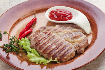 Grilled pork neck steak with ketchup