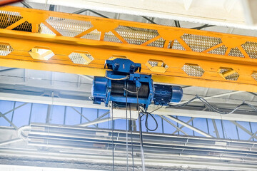 In the metalworking workshop there is a working electric drive of an overhead crane.