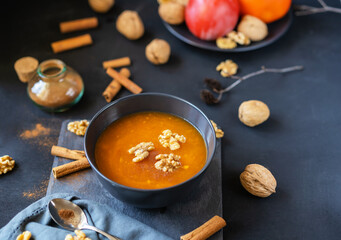 Persimmon fruit smashed in a bowl on the dark background