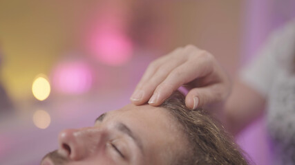 Hand healing touch on head therapy alternative close-up