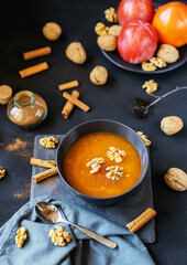 Persimmon fruit smashed in a bowl on the dark background