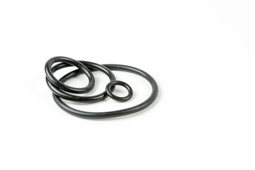 Black hydraulic and pneumatic o-rings in different sizes on a white background. O-rings for...