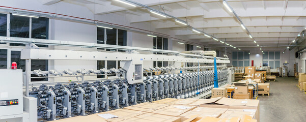 Textile yarn warping machine production industry equipment at manufacture background.machinery and equipment in the textile factory.Panoramic view.