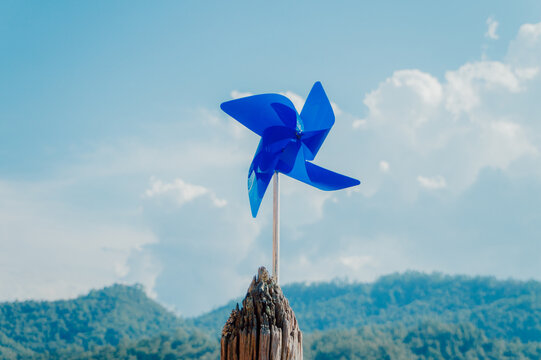 Blue windmill against a background of sky and clouds