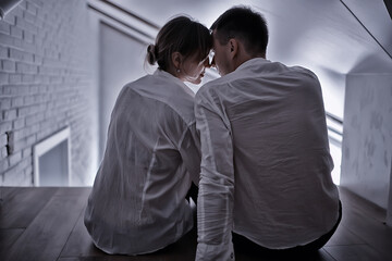 Fototapeta premium couple in love at home view from the back, man and woman relationship concept