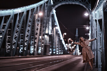 girl in a coat, spring glance, night walk in budapest chain bridge landscape