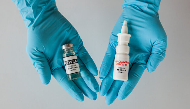 Booster shots of intranasal and liquid covid vaccine in the nurse's hand