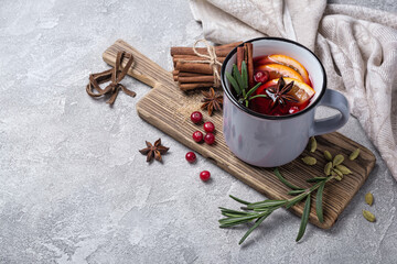 Mulled wine with slices of citrus fruits, berries and aromatic spices