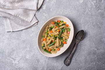 Bowl of Italian rotini pasta with vegetables