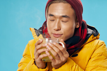 Asian man in winter jacket warming drink lifestyle