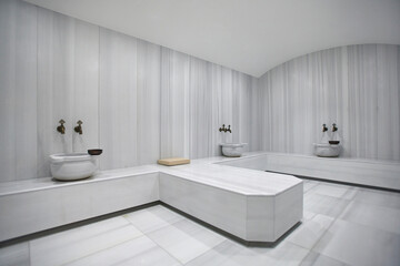Traditional Turkish bath material, interior, marble wall and sink. - obrazy, fototapety, plakaty
