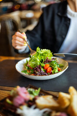 woman eating salad in the restaurant