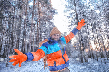 man traveler with a backpack in the forest, winter view in the american forest, north america...