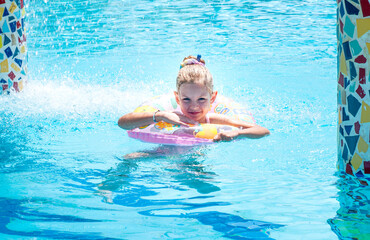 Little girl swiming in the pool