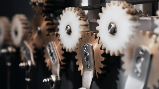 Close-up of brass gears spinning inside complex engine mechanism. Mechanics, teamwork, steampunk concept.