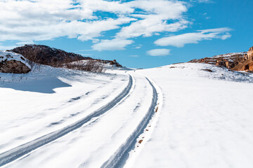 Car track on snow in highlands