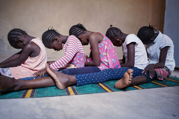Group of children sitting on ground on ritual