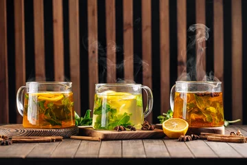 Poster Side view on three glass pots of various hot tea  © Hihitetlin