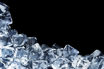 Ice cubes are poured in the corner and form a jagged triangle isolated on a black background.
