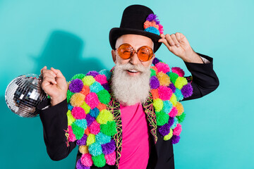 Photo of excited shiny mature showman dressed craft pom-pom jacket holding disco ball isolated...