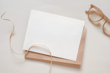 Mockup paper and kraft envelope copy space. Flat lay beige natural background