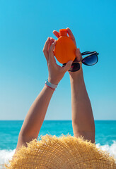 Sunscreen in the hands of a woman. Selective focus.