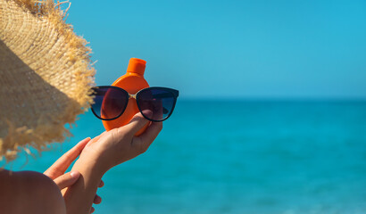 Sunscreen in the hands of a woman. Selective focus.