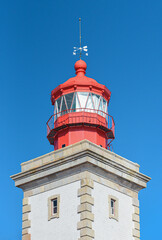 Close up of red lighthouse with direction indicator on top. Ponta da Piedade lighthouse, in Lagos, Algarve, Portugal