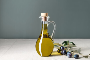 Extra virgin olive oil and olive branch in the bottle on the table with linen tablecloth. Healthy...