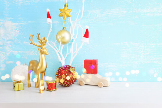 Image of christmas decorations and gold deer in front of pastel blue background