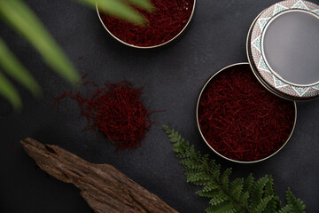 Dried saffron and crocus flowers on table, closeup