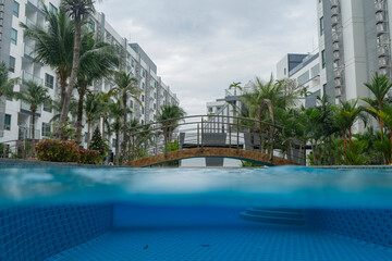 Filming to the floor of the water in the pool of the condominium.
