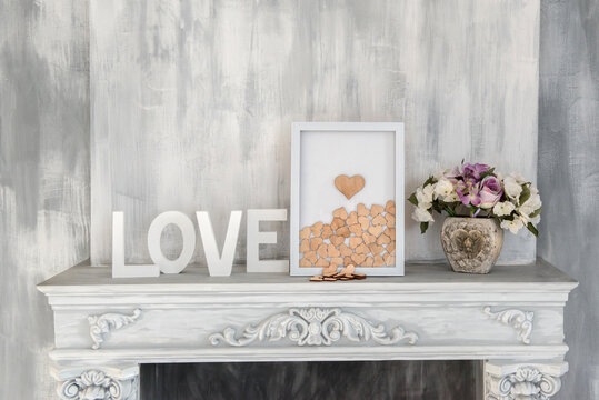 Composition for Valentine's, Mother's or Women's Day. White picture with wooden heart on old gray white background. Still-life.