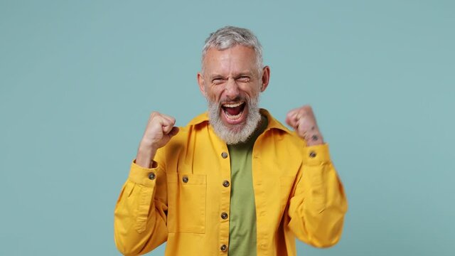Fun elderly gray-haired bearded man 50s wears yellow shirt countdown 1 2 3 one two three go celebrate win scream do winner hands gesture isolated on plain pastel light blue background studio portrait