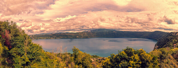 Panoramic view of lake of Albano and Castel Gandolfo and its beautiful wild environment and vegetation of volcano lake's banks located at Roman Castles Regional Park a beautiful hilly wilderness area