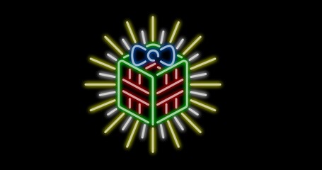 Digital composite of illuminated rays behind christmas present with copy space on black background