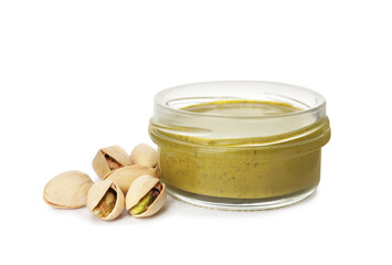 Jar with delicious pistachio butter and nuts on white background