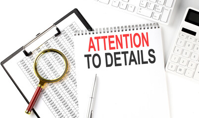 Office desk table with keyboard, notepad ,chart and calculator. Top view with text ATTENTION TO DETAILS