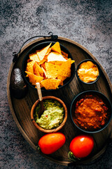 Mexican nachos with guacamole, cheddar cheese and chili.